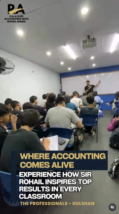 Rohail Ahmed teaching accounting at the whiteboard while students take notes