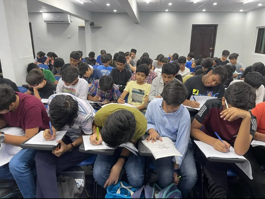 Rows of students concentrating on written classroom work